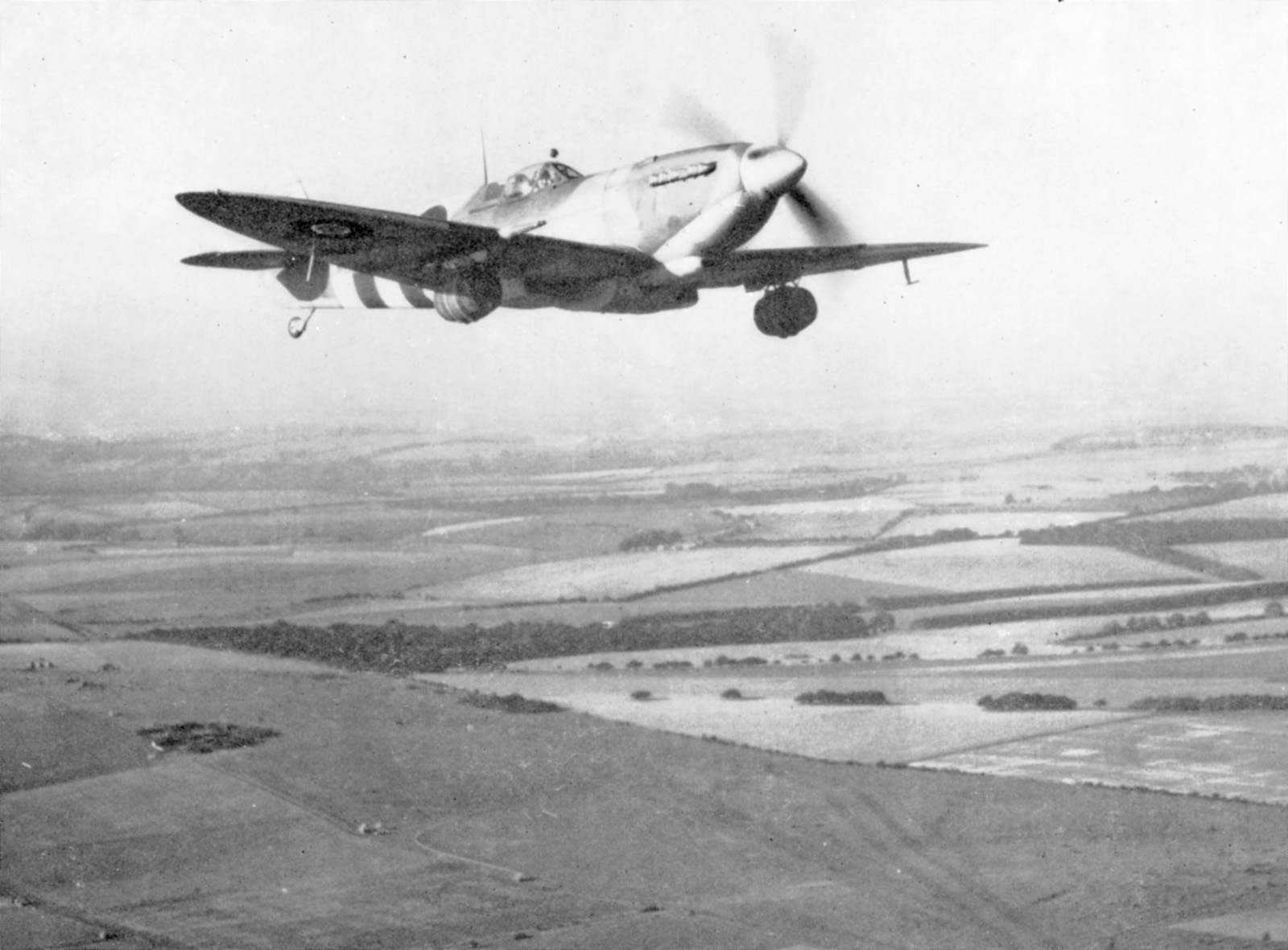 A MKIX Spitfire with two beer barrels under the wings at Spitfires.com