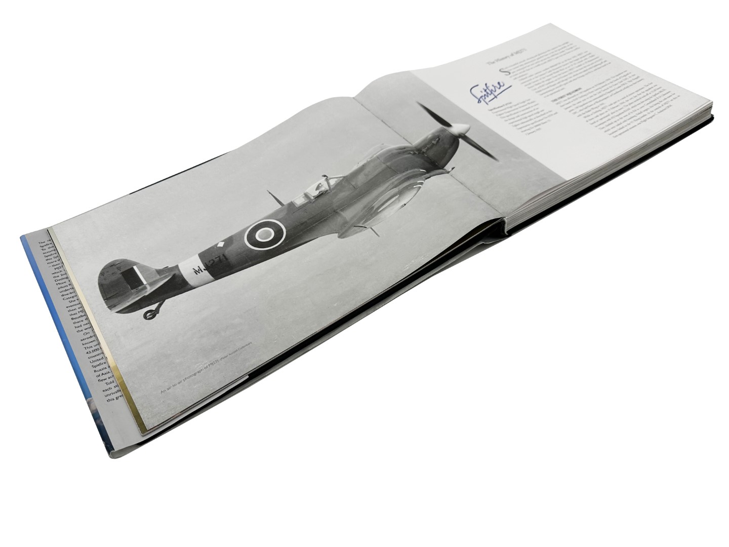Open book showing an image of the MJ271 flying during WW2.